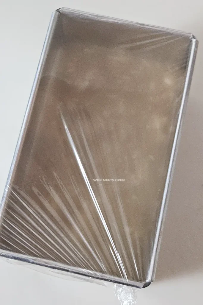 Covering container with plastic wrap