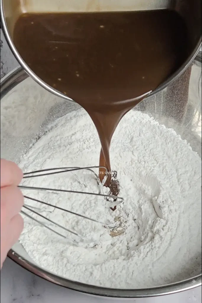Adding in coconut brown sugar water into flour