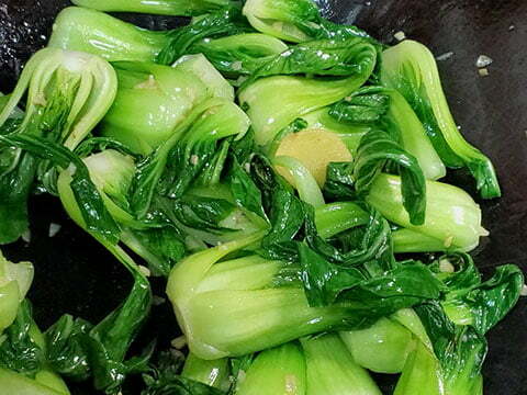 Stir-frying Bok choy in wok