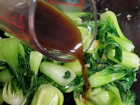 Adding in sauce to Bok choy