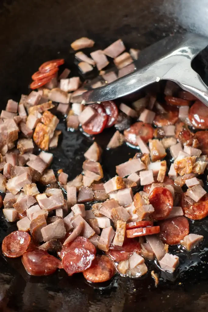 Adding in char siu to wok