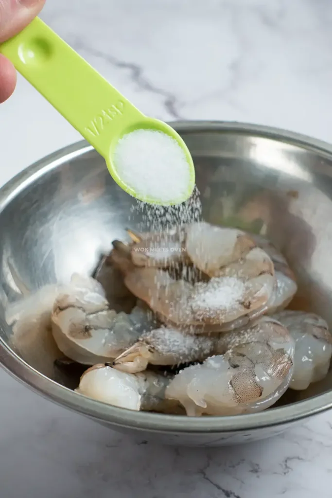 Adding salt to shrimp