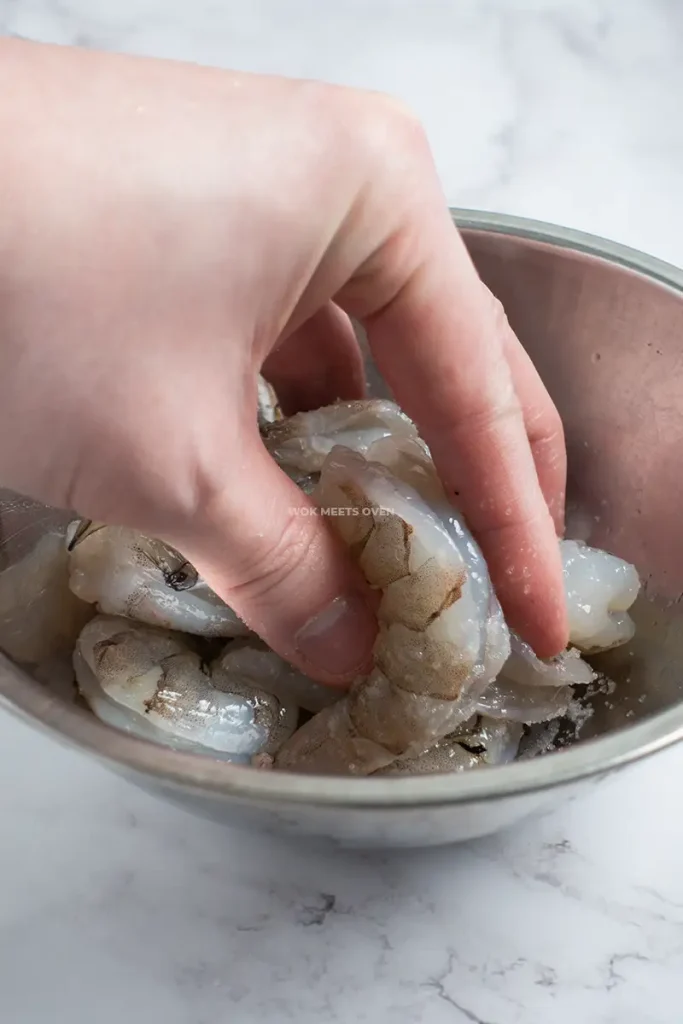 Rubbing shrimp with salt