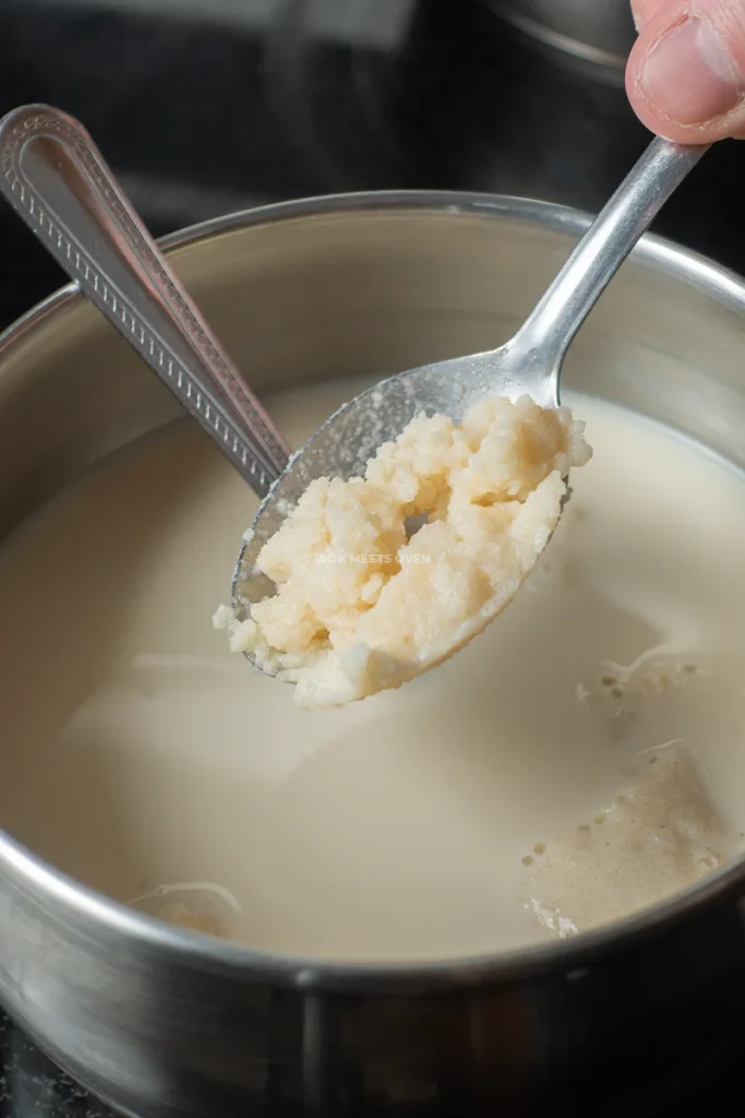 adding in gelatine paste to soy milk in pot