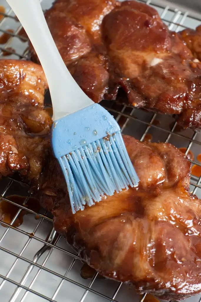 Brushing honey glaze onto char siu