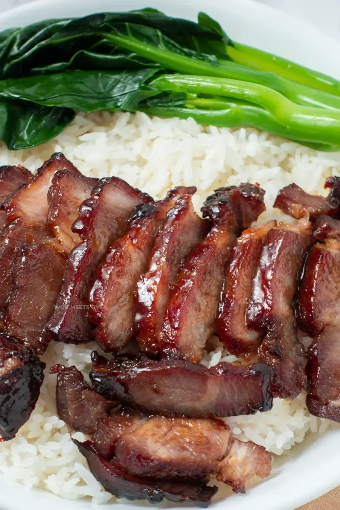 Blog image of char siu on top of bowl of rice with Chinese vegetable