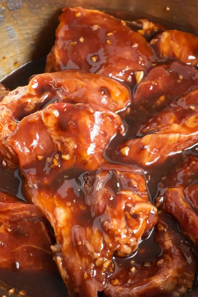 Mixed pork shoulder with marinade in bowl