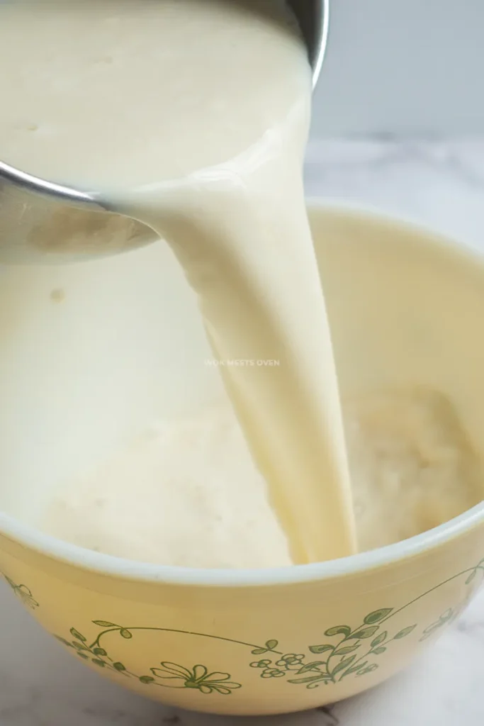 Pouring soy milk on top of gypsum powder mixed with water and cornstarch