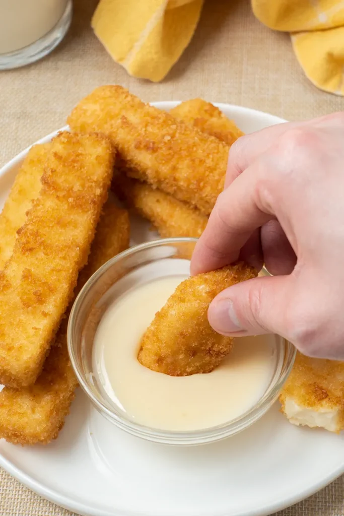 Dipping fried milk into condensed milk