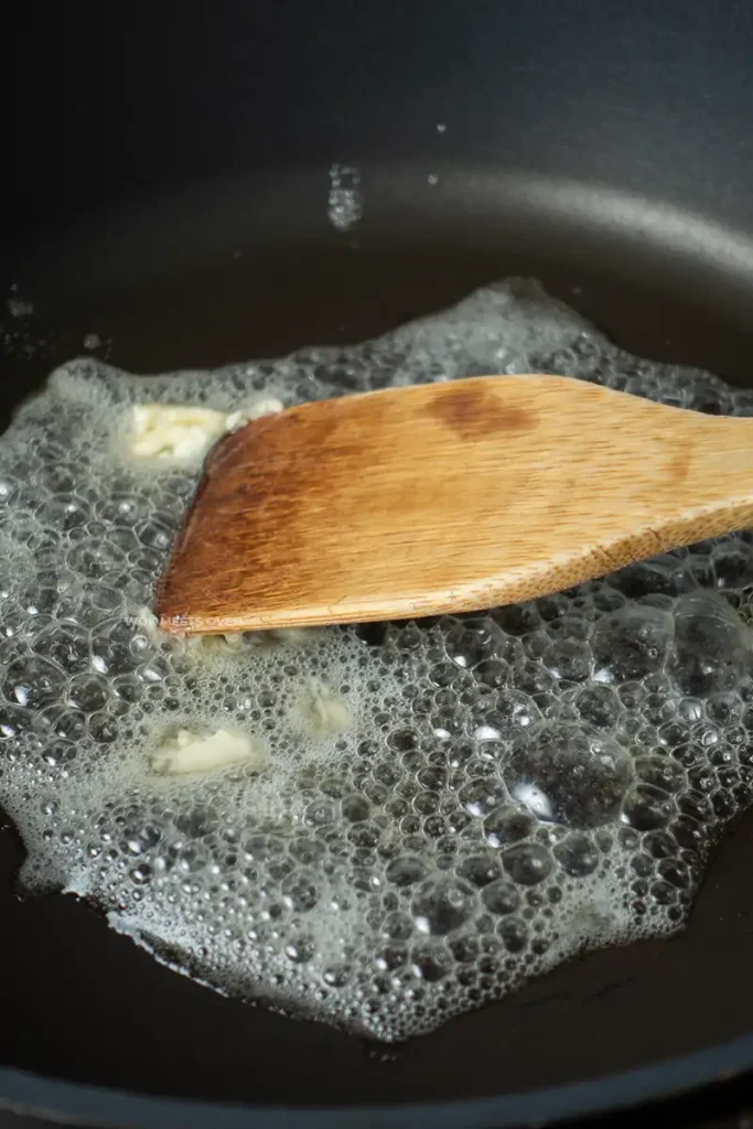 Adding in butter to a frying pan