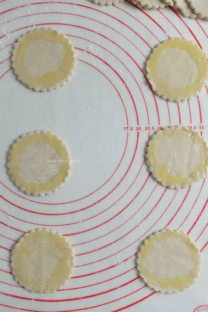 adding in egg wash to puff pastry pieces