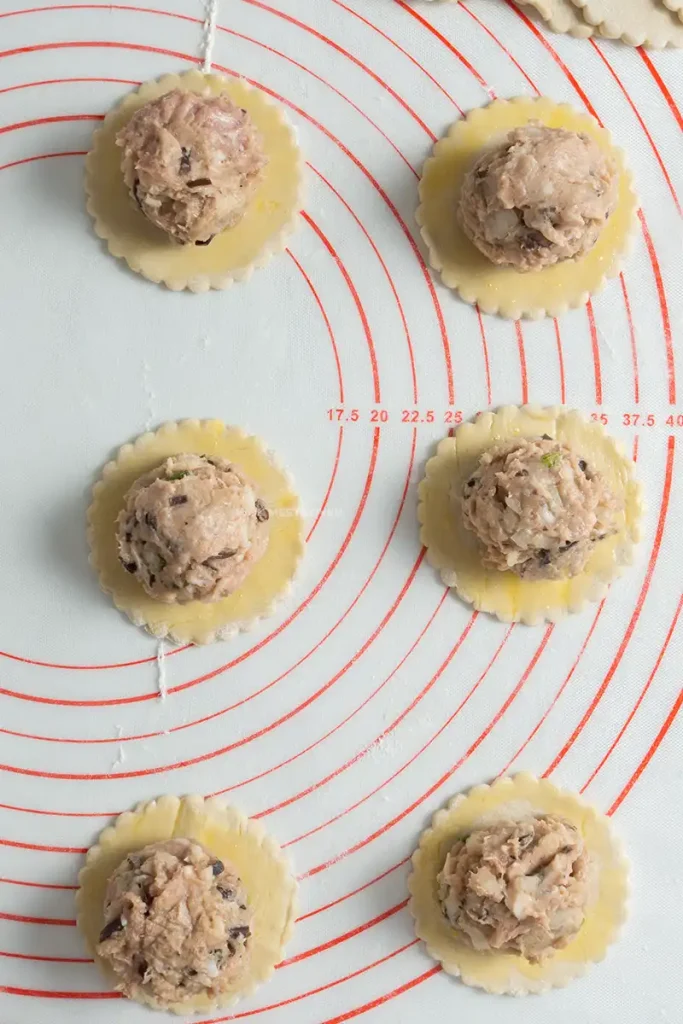 Adding in filling to puff pastry pieces