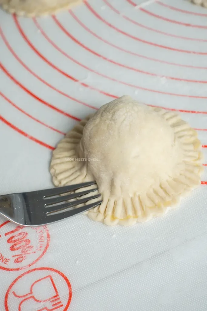 Sealing puff pastry edges with a fork