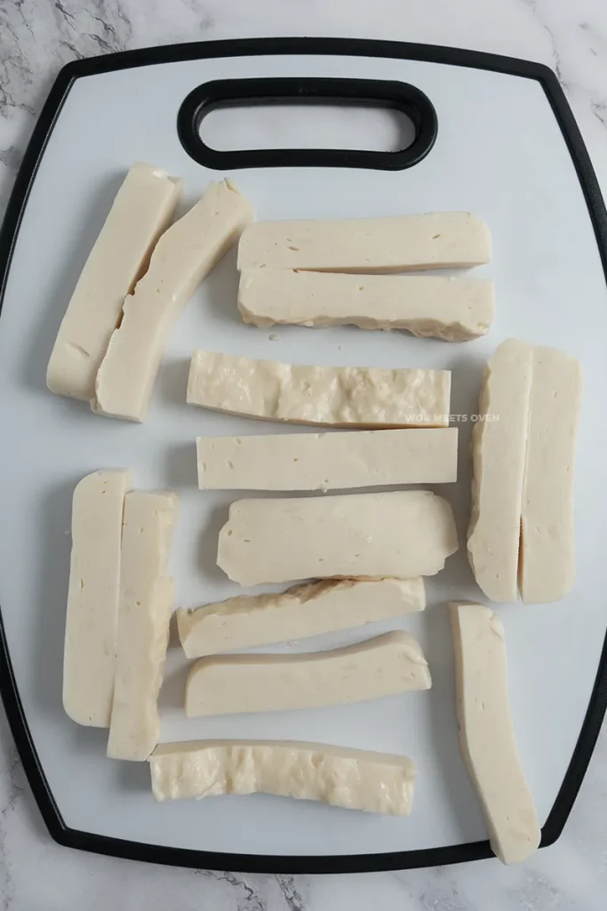 Chopped up pieces of fried milk on cutting board