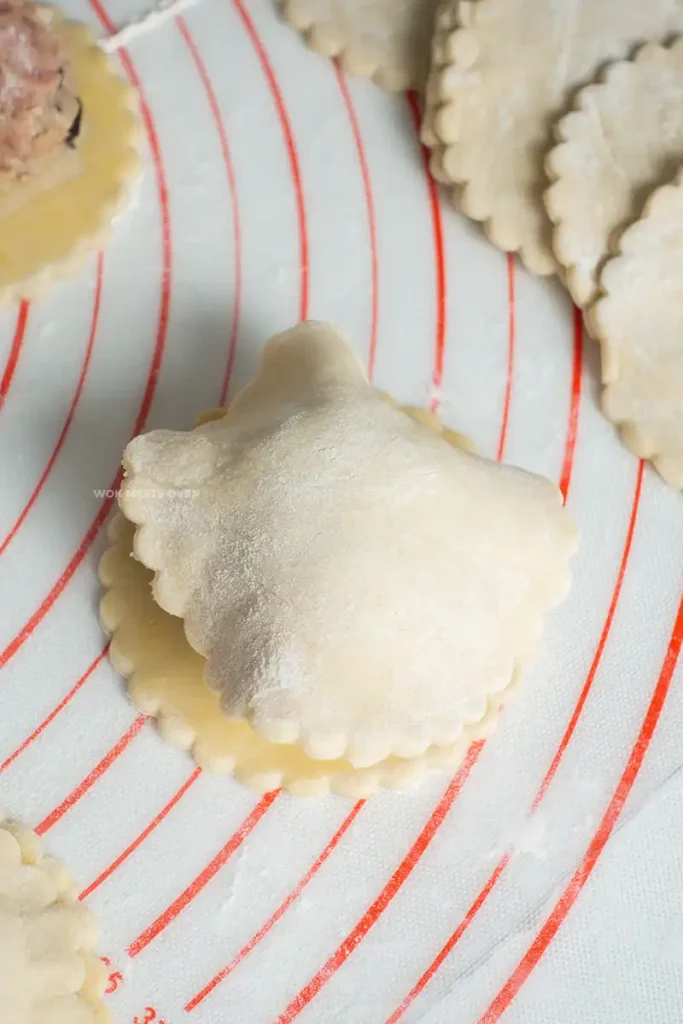 Placing another piece of puff pastry on top of puff pastry piece