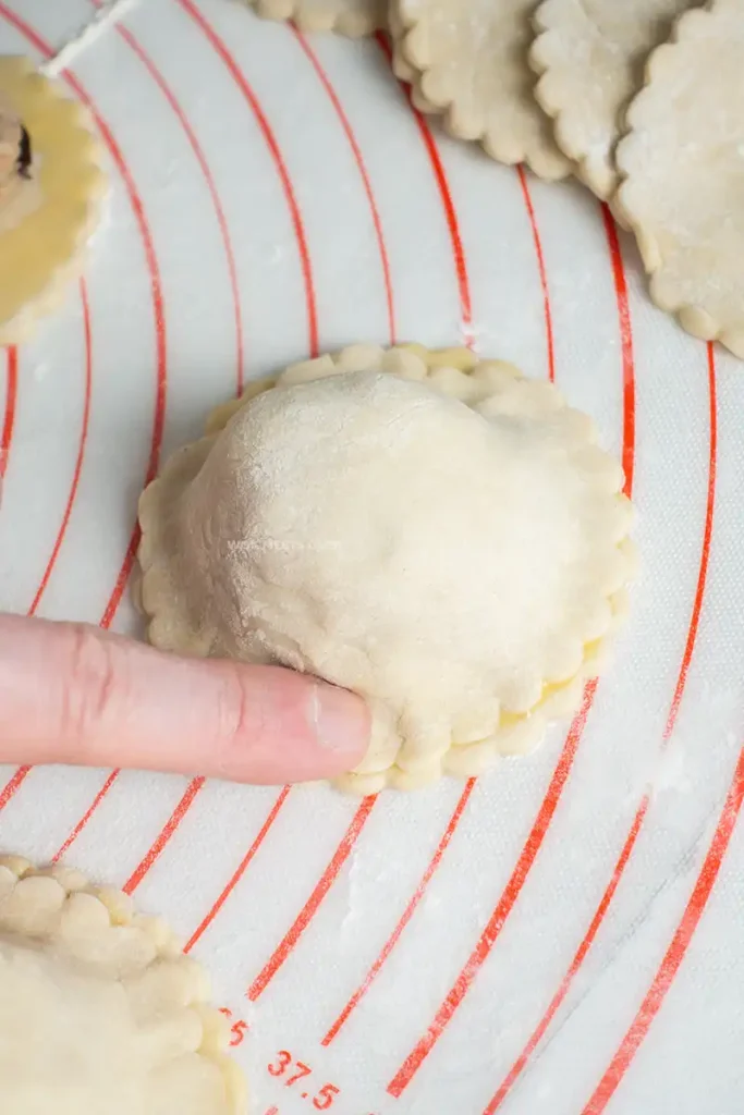 Using fingers to seal puff pastry