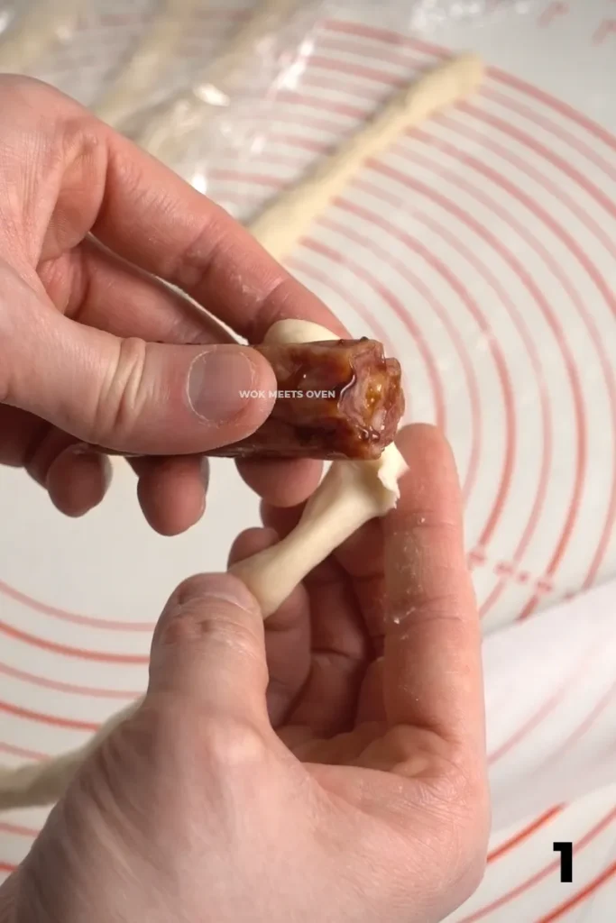Wrapping dough around Chinese sausage pic 1