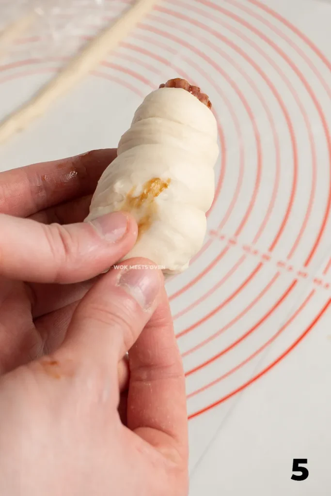 Wrapping dough around Chinese sausage pic 5