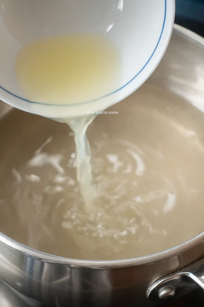 Adding in lemon juice to pot