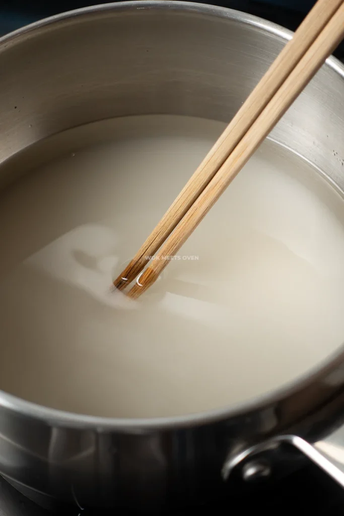 Stirring pot with chopsticks