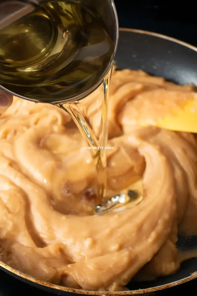 Adding in cooking oil to frying pan