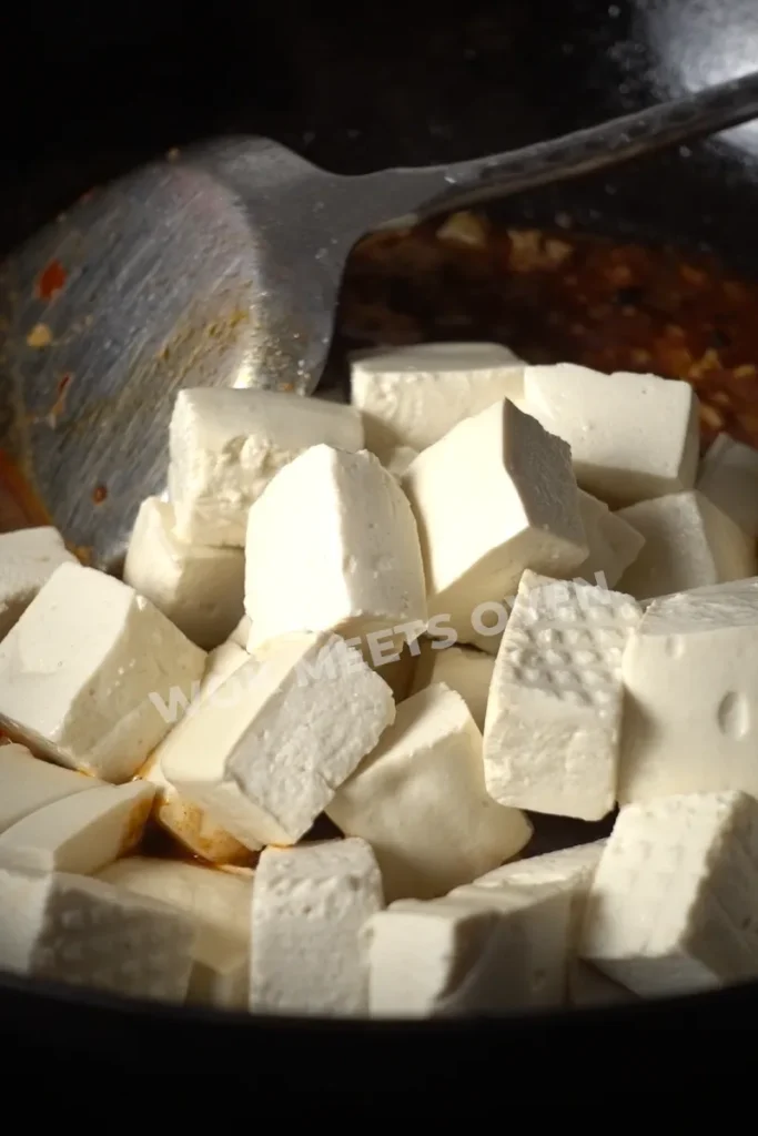 Tofu added back to wok