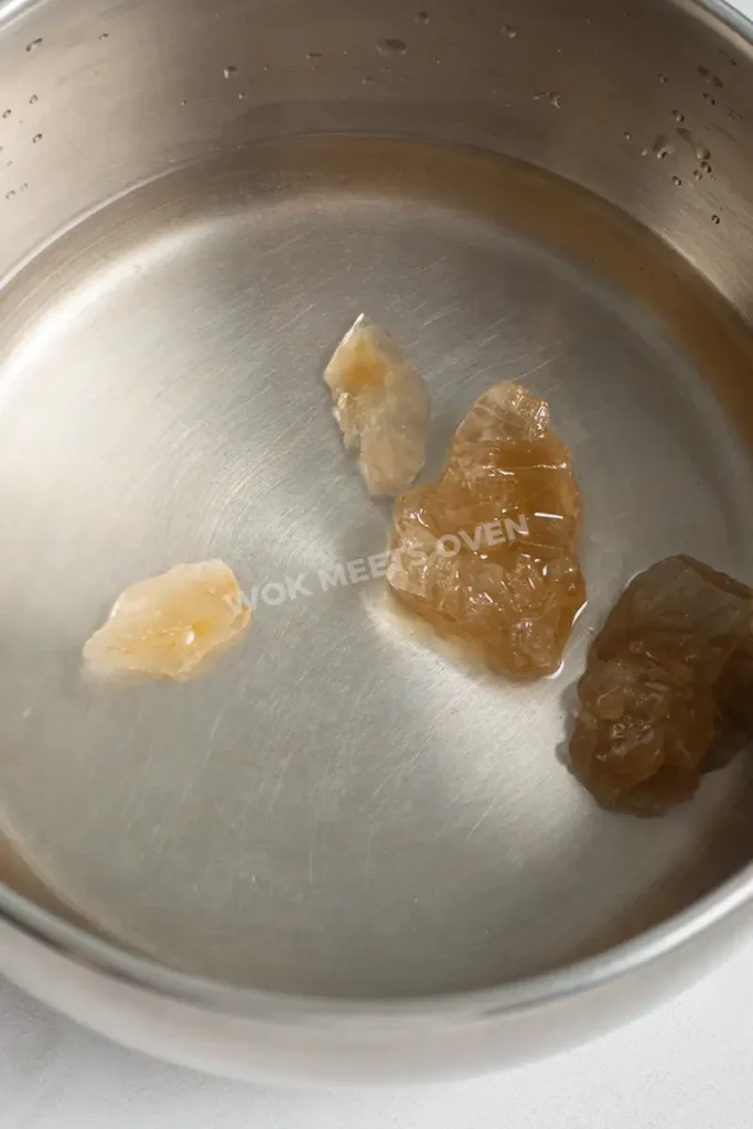 Melting rock sugar in pot of water