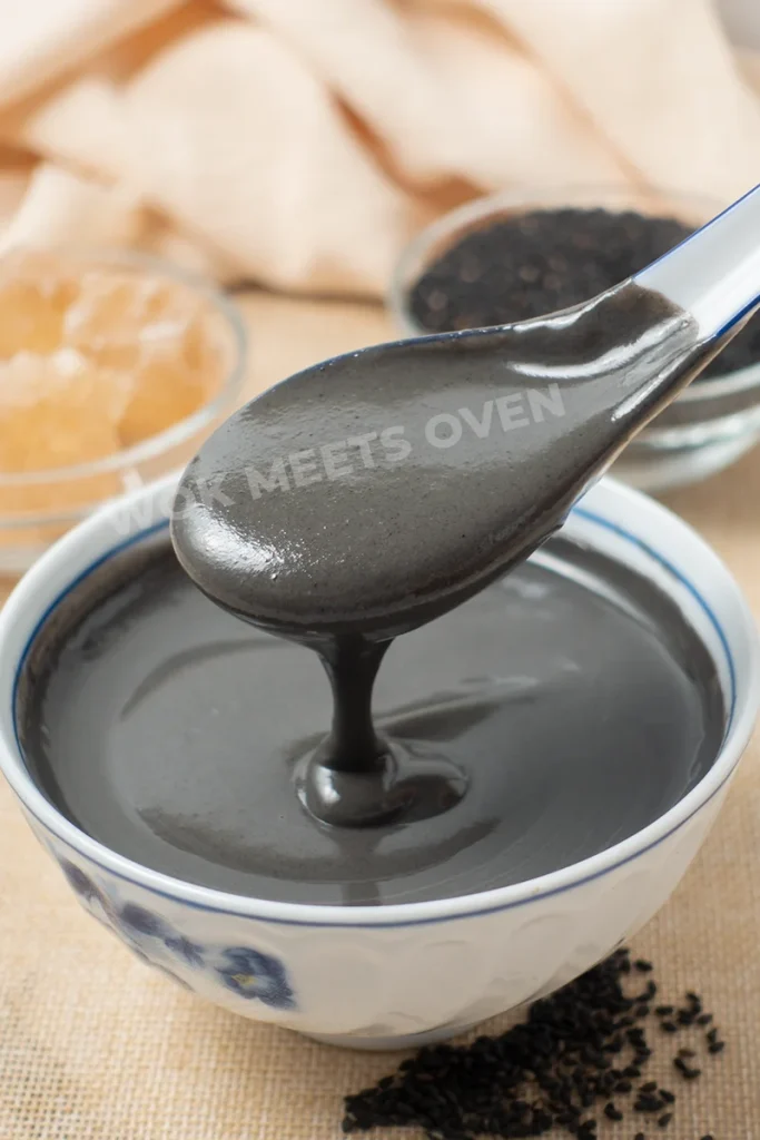 Spoon scooping up black sesame dessert soup