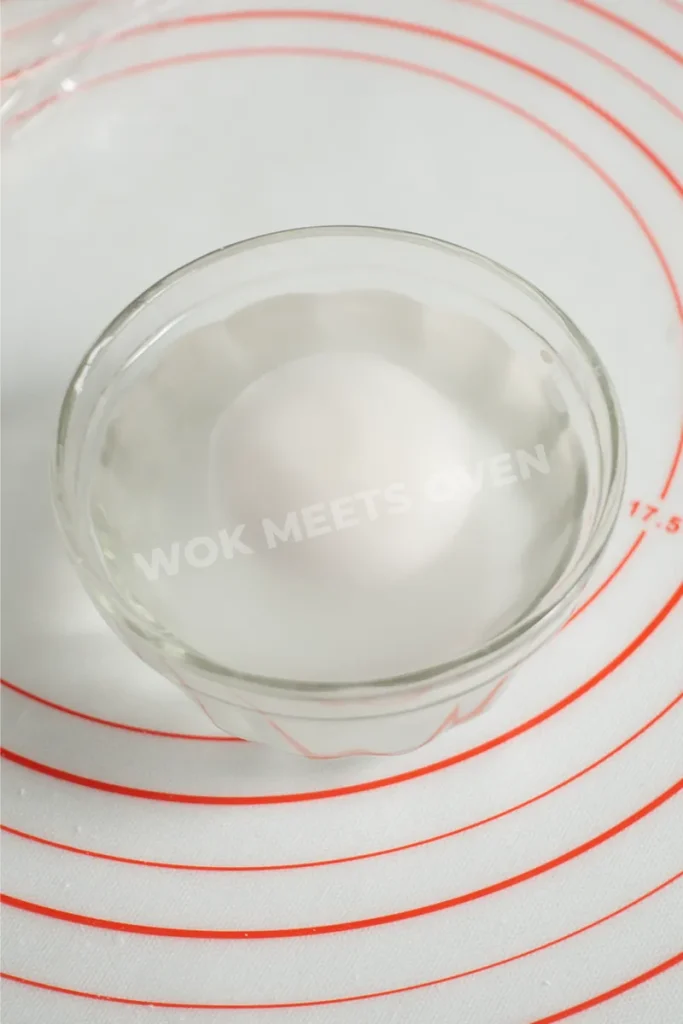 Dough ball in bowl of water