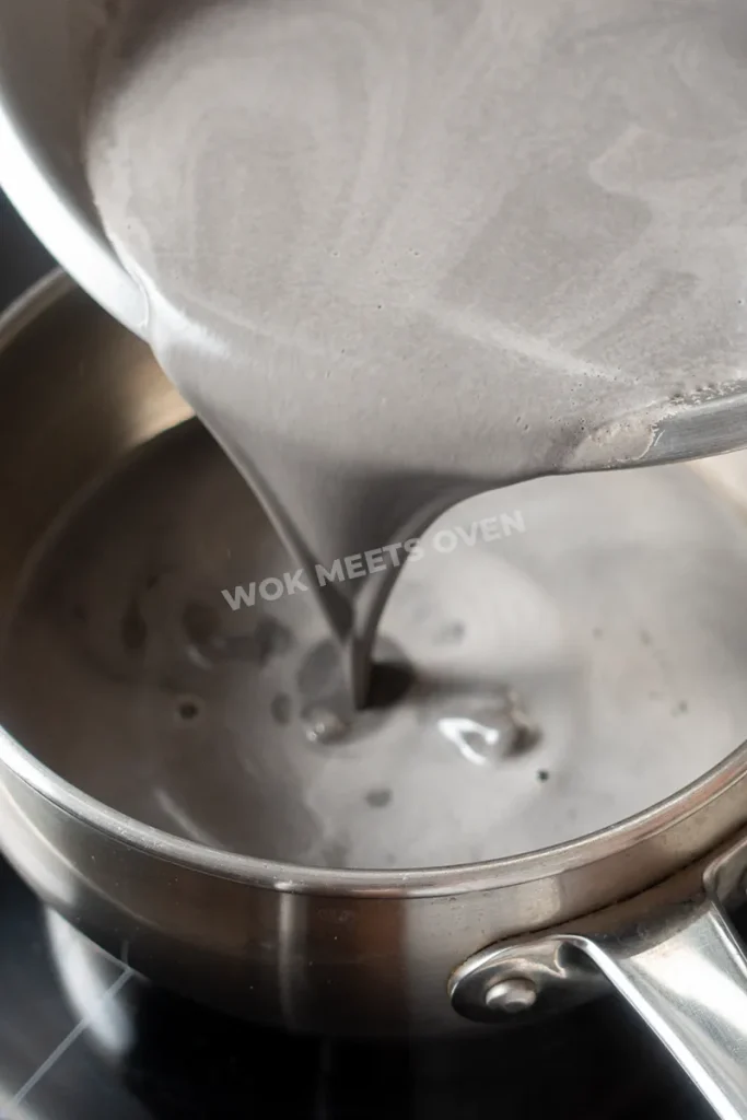 Pouring black sesame liquid into pot