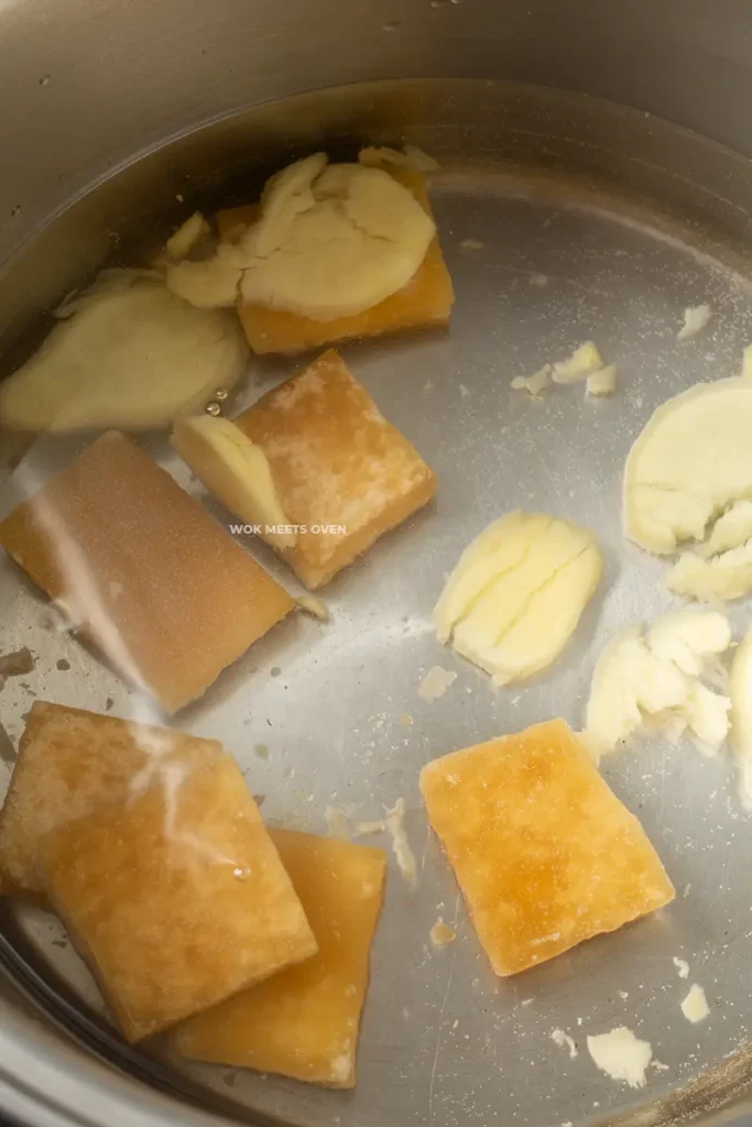 Ginger, brown sugar, and water inside of pot