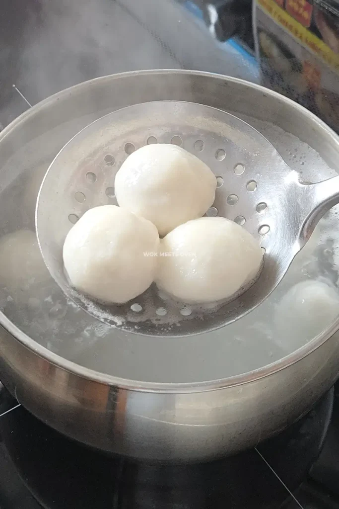 Scooping out cooked tang yuan
