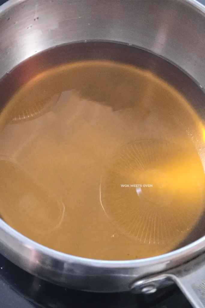 Melted brown sugar in pot of water